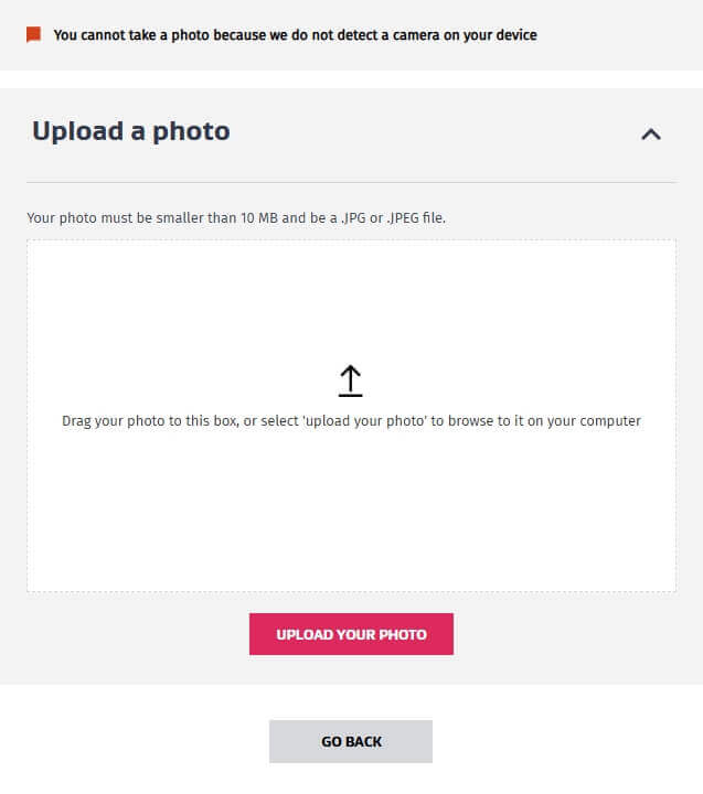 畫面顯示上傳照片的操作介面,提醒若電腦無鏡頭將無法即時拍攝照片。使用者需上傳小於10MB的JPG或JPEG格式檔案,可拖曳照片至框內或點擊「Upload your photo」上傳。頁面底部提供「Go Back」按鈕以返回前一步操作。